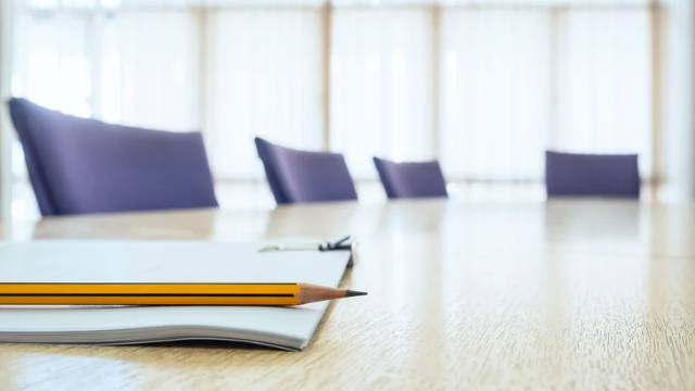 Empty boardroom table set for a board meeting