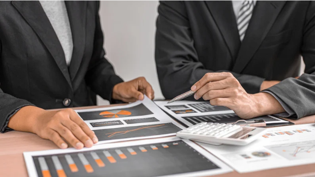 Investors reviewing financial reports and charts